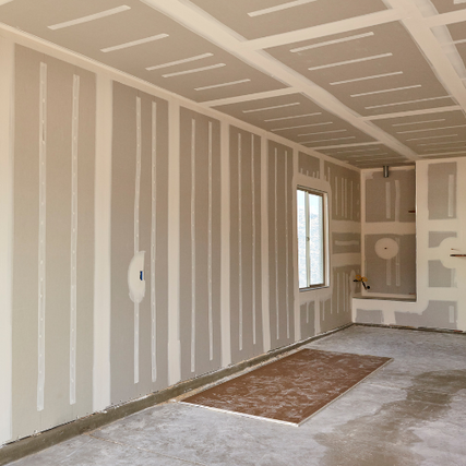 DrywallDrywall installed on walls, inside of a building being renovated.